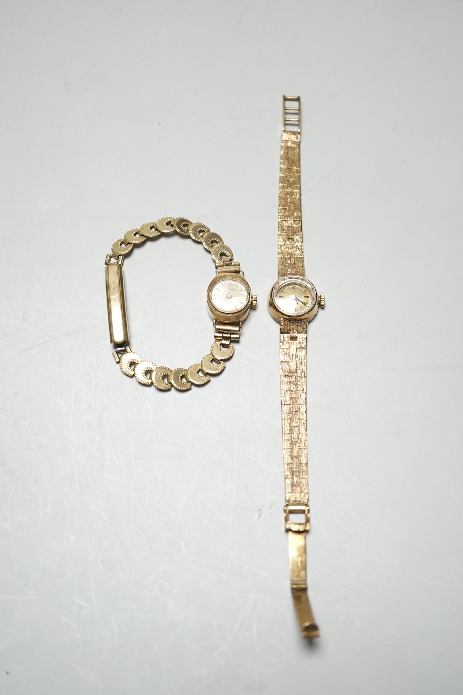 A lady's 9ct gold Omega manual wind wrist watch, on associated 9ct gold bracelet, overall 15.8cm, gross weight 17.8 grams and one other lady's 9ct gold watch on a gold plated bracelet.